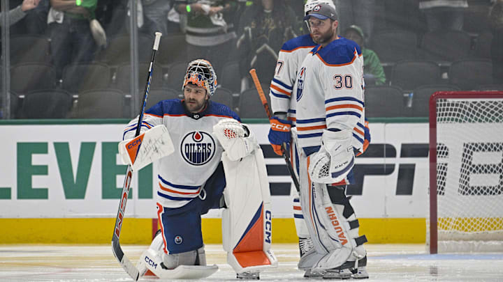 May 23, 2024; Dallas, Texas, USA; Edmonton Oilers goaltender Stuart Skinner (74) and goaltender Calvin Pickard (30) look on a center Connor McDavid (not pictured) is checked by the referees during the second overtime period against the Dallas Stars in game one of the Western Conference Final of the 2024 Stanley Cup Playoffs at American Airlines Center. Mandatory Credit: Jerome Miron-Imagn Images