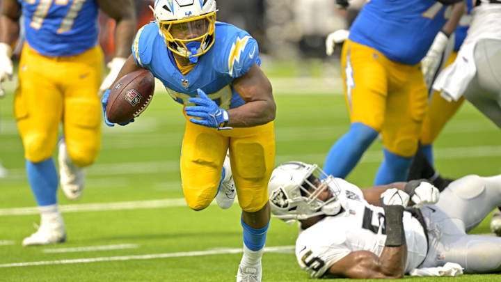 Sep 8, 2024; Inglewood, California, USA; Los Angeles Chargers running back J.K. Dobbins (27) breaks away from Las Vegas Raiders linebacker Divine Deablo (5) and runs for a touchdown in the second half at SoFi Stadium. Mandatory Credit: Jayne Kamin-Oncea-Imagn Images