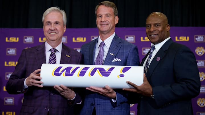 Dec 1, 2025; Baton Rouge, LA, USA; LSU president Wade Rousse, left, LSU new head coach Lane Kiffin and LSU athletic director Verge Ausberry stand together at South Stadium Club at Tiger Stadium. Mandatory Credit: Matthew Hinton-Imagn Images Dec 1, 2025; Baton Rouge, LA, USA; LSU president Wade Rousse, left, LSU new head coach Lane Kiffin and LSU athletic director Verge Ausberry stand together at South Stadium Club at Tiger Stadium. Mandatory Credit: Matthew Hinton-Imagn Images