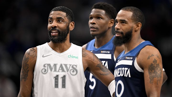 Jan 22, 2025; Dallas, Texas, USA; Dallas Mavericks guard Kyrie Irving (11) talks with Minnesota Timberwolves guard Anthony Edwards (5) and guard Mike Conley (10) during the first quarter at the American Airlines Center.