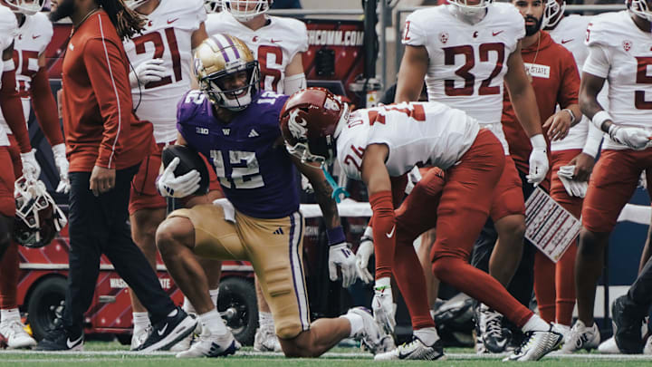Denzel Boston offers a few words to a Washington State defensive back. 