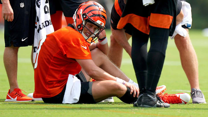 Cincinnati Bengals quarterback Joe Burrow (9) grabs his calf after an injury on a scramble play