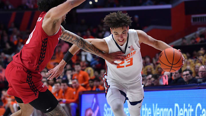 Feb 10, 2026; Champaign, Illinois, USA;  Illinois Fighting Illini guard Keaton Wagler (23) drives the ball against Wisconsin Badgers guard Braedon Carrington (0) during the first half at State Farm Center. Mandatory Credit: Ron Johnson-Imagn Images