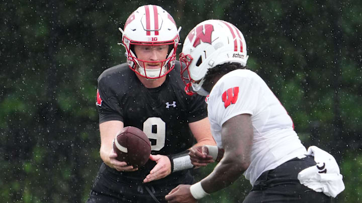 Wisconsin quarterback Billy Edwards Jr. (9) gives a handoff to running back Darrion Dupree (6) during football practice, July 30, 2025, at Ralph E. Davis Pioneer Stadium in Platteville, Wisconsin.