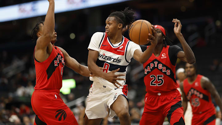 Oct 11, 2024; Washington, District of Columbia, USA; Washington Wizards guard Bub Carrington (8) leaps to pass the ball Toronto Raptors forward Scottie Barnes (4) defends in the second quarter at Capital One Arena. Oct 11, 2024; Washington, District of Columbia, USA; Washington Wizards guard Bub Carrington (8) leaps to pass the ball Toronto Raptors forward Scottie Barnes (4) defends in the second quarter at Capital One Arena.