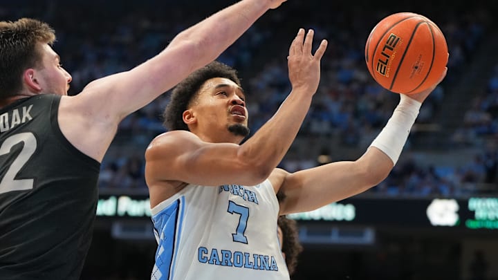 Feb 28, 2026; Chapel Hill, North Carolina, USA; North Carolina Tar Heels guard Seth Trimble (7) shoots as Virginia Tech Hokies center Christian Gurdak (32) defends in the second half at Dean E. Smith Center. Mandatory Credit: Bob Donnan-Imagn Images