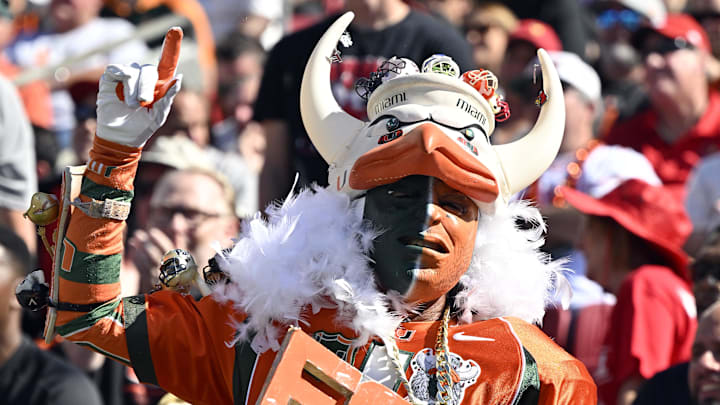Oct 19, 2024; Louisville, Kentucky, USA; A Miami Hurricanes fan cheers during the first half against the Louisville Cardinals at L&N Federal Credit Union Stadium. Mandatory Credit: Jamie Rhodes-Imagn Images Oct 19, 2024; Louisville, Kentucky, USA; A Miami Hurricanes fan cheers during the first half against the Louisville Cardinals at L&N Federal Credit Union Stadium. Mandatory Credit: Jamie Rhodes-Imagn Images