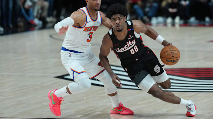 Mar 12, 2025; Portland, Oregon, USA: Portland Trail Blazers guard Scoot Henderson (00) dribbles the ball against New York Knicks shooting guard Josh Hart (3) during overtime at Moda Center. Mandatory Credit: Soobum Im-Imagn Images