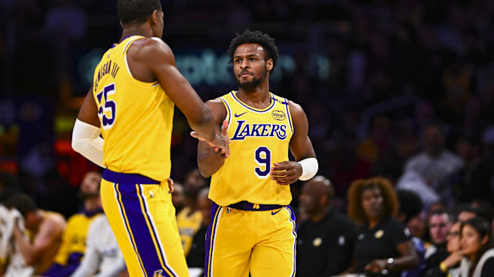 Apr 11, 2025; Los Angeles, California, USA; Los Angeles Lakers guard Bronny James Jr. (9) celebrates with center Trey Jemison III (55) after scoring against the Houston Rockets during the second half at Crypto.com Arena. Mandatory Credit: Jonathan Hui-Imagn Images