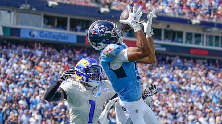 Tennessee Titans wide receiver Elic Ayomanor (5) pulls down a touchdown ahead of Los Angeles Rams cornerback Emmanuel Forbes Jr. (1) during the second quarter at Nissan Stadium in Nashville, Tenn., Sunday, Sept. 14, 2025.