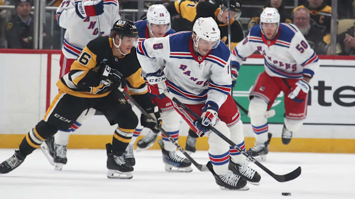Feb 23, 2025; Pittsburgh, Pennsylvania, USA;  New York Rangers left wing J.T. Miller (8) skates with the puck against the Pittsburgh Penguins during the second period at PPG Paints Arena. Mandatory Credit: Charles LeClaire-Imagn Images