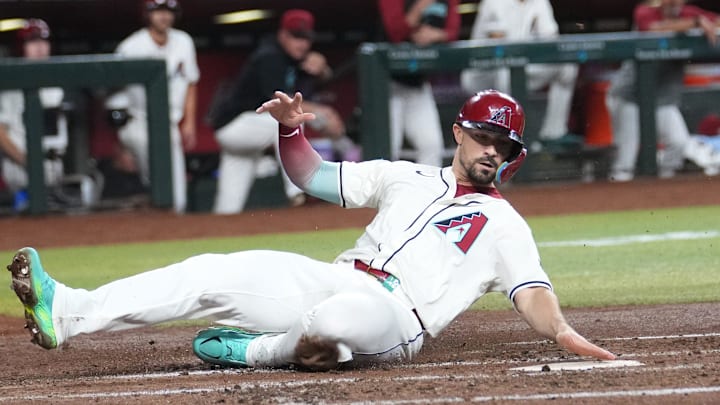 Arizona Diamondbacks Randal Grichuk slides in safely to score a run against the San Diego Padres at Chase Field in Phoenix. 