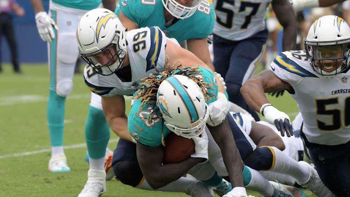 Los Angeles Chargers defensive end Joey Bosa (99) tackles Miami Dolphins running back Jay Ajayi (23) during a NFL football game at StubHub Center in 2017. Los Angeles Chargers defensive end Joey Bosa (99) tackles Miami Dolphins running back Jay Ajayi (23) during a NFL football game at StubHub Center in 2017.