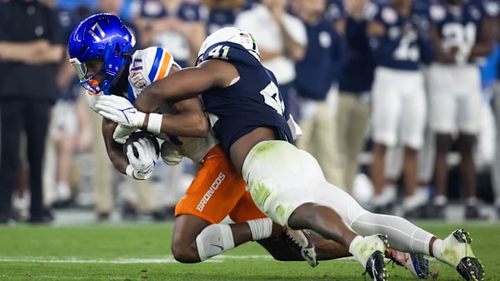 Dec 31, 2024; Glendale, AZ, USA; Penn State Nittany Lions linebacker Kobe King (41) tackles Boise State Broncos wide receiver Prince Strachan (17) during the Fiesta Bowl at State Farm Stadium. Dec 31, 2024; Glendale, AZ, USA; Penn State Nittany Lions linebacker Kobe King (41) tackles Boise State Broncos wide receiver Prince Strachan (17) during the Fiesta Bowl at State Farm Stadium.