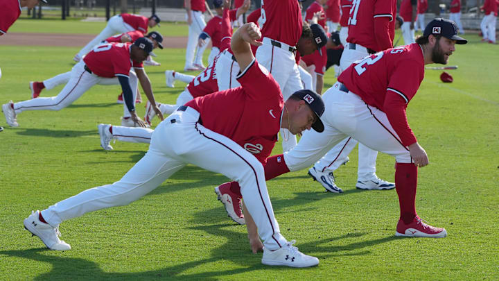 Feb 15, 2025; West Palm Beach, FL, USA; Washington Nationals pitcher MacKenzie Gore, front, and teammates warm-up before the start of Spring Training activities.