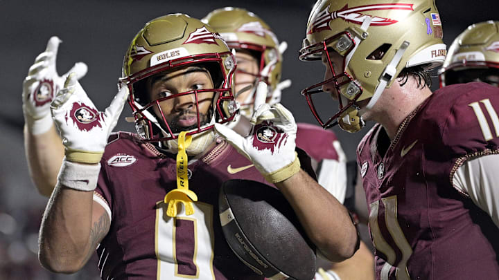 Oct 5, 2024; Tallahassee, Florida, USA; Florida State Seminoles wide receiver Ja'Khi Douglas (0) celebrates with quarterback Brock Glenn (11) after a touchdown against the Clemson Tigers during the second half at Doak S. Campbell Stadium. Mandatory Credit: Melina Myers-Imagn Images