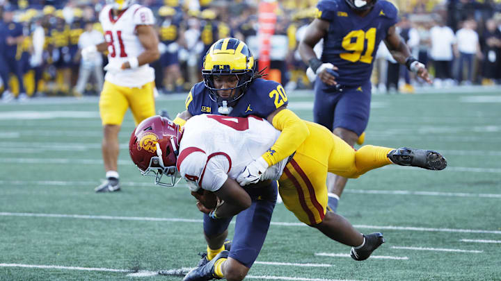 Sep 21, 2024; Ann Arbor, Michigan, USA; USC Trojans running back Woody Marks (4) is tackled by Michigan Wolverines defensive back Jyaire Hill (20) in the second half at Michigan Stadium. Mandatory Credit: Rick Osentoski-Imagn Images Sep 21, 2024; Ann Arbor, Michigan, USA; USC Trojans running back Woody Marks (4) is tackled by Michigan Wolverines defensive back Jyaire Hill (20) in the second half at Michigan Stadium. Mandatory Credit: Rick Osentoski-Imagn Images