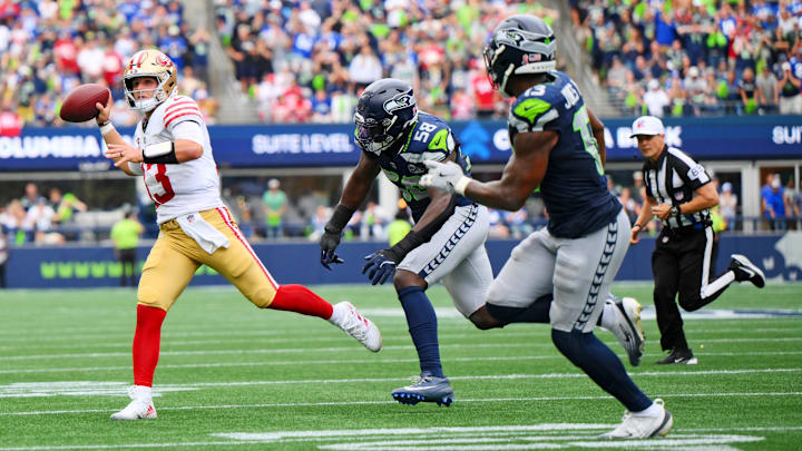 Sep 7, 2025; Seattle, Washington, USA; San Francisco 49ers quarterback Brock Purdy (13) throws a touch down pass during the second half against Seattle Seahawks at Lumen Field. Mandatory Credit: Steven Bisig-Imagn Images