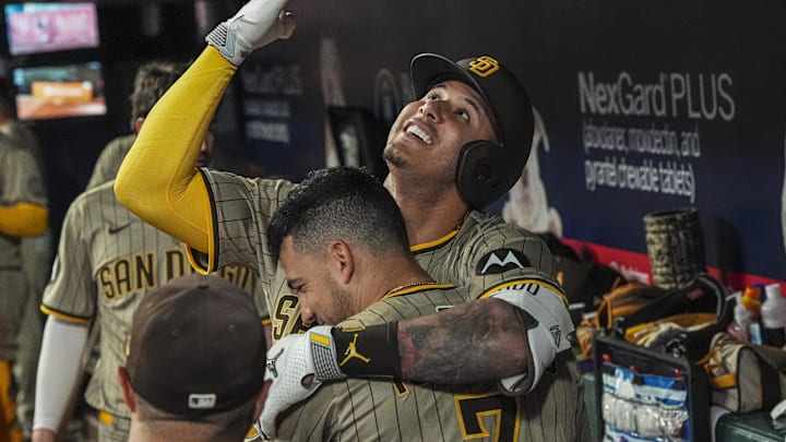 May 23, 2025; Cumberland, Georgia, USA; San Diego Padres third baseman Manny Machado (13) reacts in the dugout with second baseman Jose Iglesias (7) after hitting a go ahead home run against the Atlanta Braves during the ninth inning at Truist Park. Mandatory Credit: Dale Zanine-Imagn Images