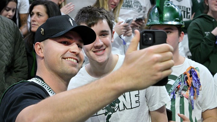 Jan 19, 2025; East Lansing, Michigan, USA;  Cy Young award winner Tarik Skubal shoots a selfie with Michigan State Spartans fans before the game against the Illinois Fighting Illini at Jack Breslin Student Events Center. 