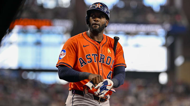 Yordan Alvarez taking off his batting gloves.