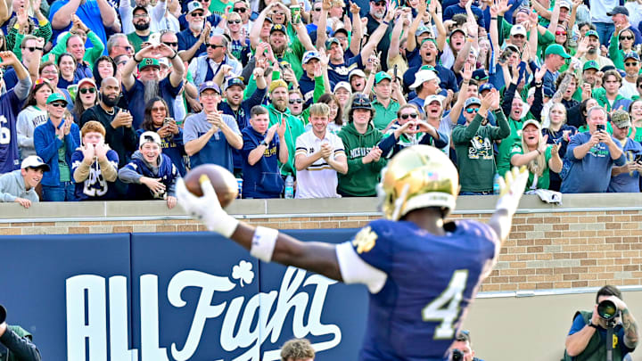 Oct 12, 2024; South Bend, Indiana, USA; Fans react after Notre Dame Fighting Irish running back Jeremiyah Love (4) ran for a touchdown in the third quarter against the Stanford Cardinal at Notre Dame Stadium. Oct 12, 2024; South Bend, Indiana, USA; Fans react after Notre Dame Fighting Irish running back Jeremiyah Love (4) ran for a touchdown in the third quarter against the Stanford Cardinal at Notre Dame Stadium.