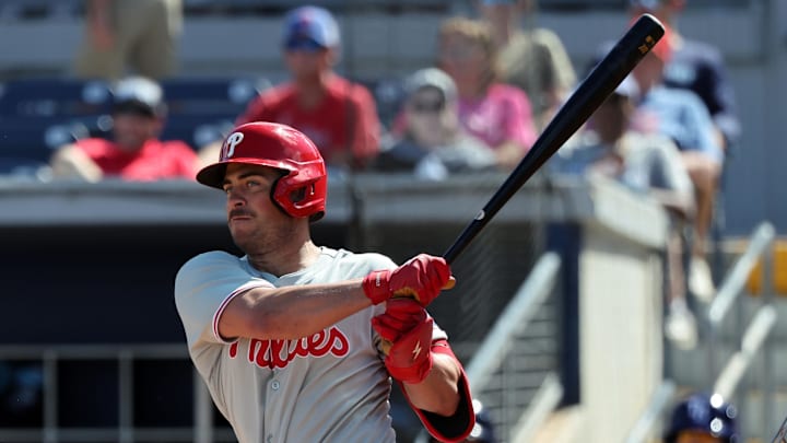 Feb 25, 2025; Port Charlotte, Florida, USA;  Philadelphia Phillies infielder Otto Kemp (82) hits a RBI double against the Tampa Bay Rays during the fourth inning at Charlotte Sports Park. 