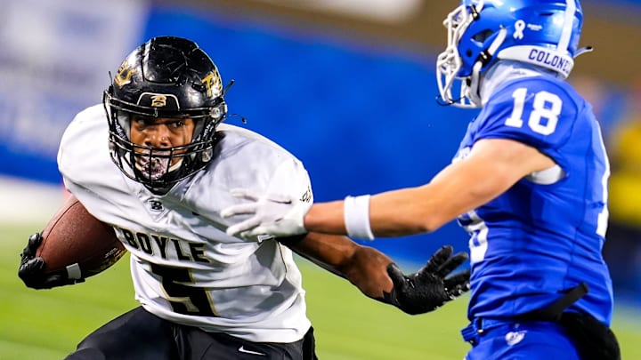 Boyle County wide receiver Montavin Quisenberry (5) stiff arms Covington Catholic Colonels defensive back Joseph Harney (18) during the KHSAA Class 4A 2023 UK HealthCare Sports Medicine state finals football game between Covington Catholic Colonels (14-0) and Boyle County Rebels (14-0) on Friday, Dec. 1, 2023, at Kroger Field in Lexington, Ky. Boyle County won 41-0.
