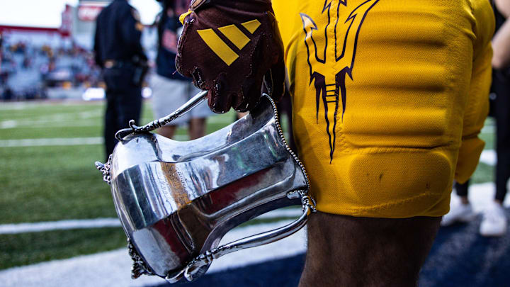 Nov 30, 2024; Tucson, Arizona, USA; Arizona State Sun Devils running back Cam Skattebo (4) holds the Territorial Cup at the end of the game against the Arizona Wildcats at Arizona Stadium. Mandatory Credit: Aryanna Frank-Imagn Images