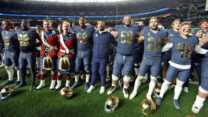 Nov 23, 2024; New York, New York, USA; Notre Dame Fighting Irish head coach Marcus Freeman and his players sing the Notre Dame alma mater after a win against the Army Black Knights at Yankee Stadium. Mandatory Credit: Danny Wild-Imagn Images Nov 23, 2024; New York, New York, USA; Notre Dame Fighting Irish head coach Marcus Freeman and his players sing the Notre Dame alma mater after a win against the Army Black Knights at Yankee Stadium. Mandatory Credit: Danny Wild-Imagn Images