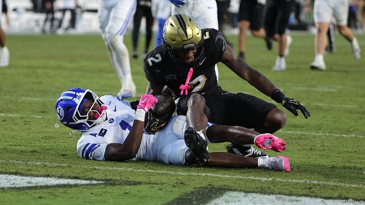 Oct 24, 2026; Orlando, Florida, USA; Central Florida Knights wide receiver Tyren Hornes (2) is tackled after a catch by Brigham Young Cougars cornerback Therrian Alexander III (1) defending during the fourth quarter at Acrisure Bounce House. Mandatory Credit: Mike Watters-Imagn Images Oct 24, 2026; Orlando, Florida, USA; Central Florida Knights wide receiver Tyren Hornes (2) is tackled after a catch by Brigham Young Cougars cornerback Therrian Alexander III (1) defending during the fourth quarter at Acrisure Bounce House. Mandatory Credit: Mike Watters-Imagn Images