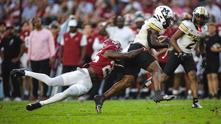 Alabama Crimson Tide defensive back Jahlil Hurley (25) grabs onto Missouri Tigers running back Marcus Carroll (9) during the fourth quarter at Bryant-Denny Stadium. 