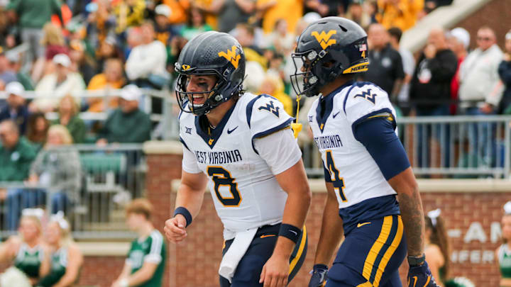 Sep 6, 2025; Athens, Ohio, USA; West Virginia Mountaineers quarterback Nicco Marchiol (8) celebrates with West Virginia Mountaineers wide receiver Cam Vaughn (4) after a touchdown during the first quarter against the Ohio Bobcats at Peden Stadium. Mandatory Credit: Ben Queen-Imagn Images