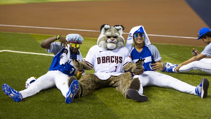 Aug 28, 2022; Phoenix, Arizona, US; East infielder Tre Phelps (left) and infielder Tai Peete (right) with Arizona Diamondbacks mascot Baxter during the Perfect Game All-American Classic high school baseball game at Chase Field. Mandatory Credit: Mark J. Rebilas-Imagn Images Aug 28, 2022; Phoenix, Arizona, US; East infielder Tre Phelps (left) and infielder Tai Peete (right) with Arizona Diamondbacks mascot Baxter during the Perfect Game All-American Classic high school baseball game at Chase Field. Mandatory Credit: Mark J. Rebilas-Imagn Images