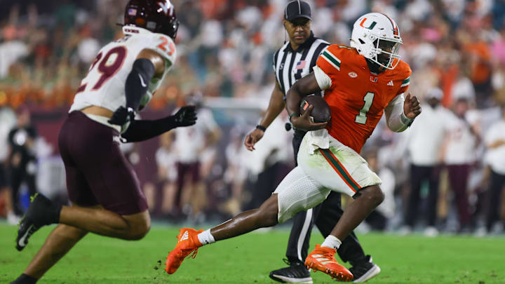 Sep 27, 2024; Miami Gardens, Florida, USA; Miami Hurricanes quarterback Cam Ward (1) runs with the football against the Virginia Tech Hokies during the fourth quarter at Hard Rock Stadium. Mandatory Credit: Sam Navarro-Imagn Images