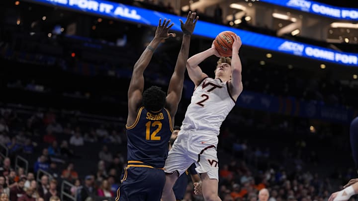 Mar 11, 2025; Charlotte, NC, USA; Virginia Tech Hokies guard Jaden Schutt (2) goes to the basket defended by California Golden Bears center Mady Sissoko (12) during the second half at Spectrum Center. Mandatory Credit: Jim Dedmon-Imagn Images Mar 11, 2025; Charlotte, NC, USA; Virginia Tech Hokies guard Jaden Schutt (2) goes to the basket defended by California Golden Bears center Mady Sissoko (12) during the second half at Spectrum Center. Mandatory Credit: Jim Dedmon-Imagn Images