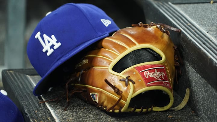 Apr 28, 2024; Toronto, Ontario, CAN; A hat and glove of an Los Angeles Dodgers player durng a game against the Toronto Blue Jays at Rogers Centre. Mandatory Credit: John E. Sokolowski-Imagn Images