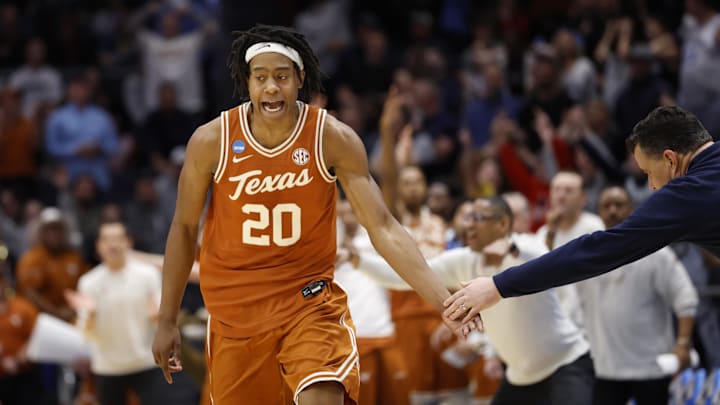 Mar 19, 2025; Dayton, OH, USA; Texas Longhorns guard Tre Johnson (20) high fives Xavier Musketeers head coach Sean Miller after making a three point basket in the second half at UD Arena. Mandatory Credit: Rick Osentoski-Imagn Images