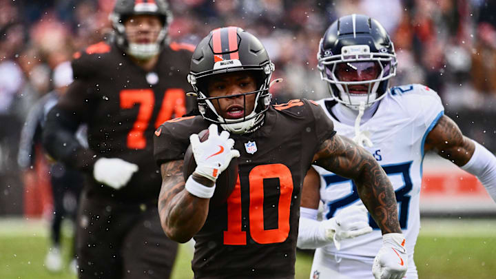 Dec 7, 2025; Cleveland, Ohio, USA; Cleveland Browns running back Quinshon Judkins (10) runs with the ball against Tennessee Titans safety Kevin Winston Jr. (23) during the first quarter at Huntington Bank Field. Mandatory Credit: Ken Blaze-Imagn Images