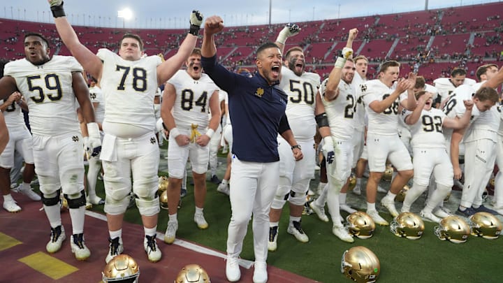 Nov 30, 2024; Los Angeles, California, USA; Notre Dame Fighting Irish head coach Marcus Freeman celebrates with players at the end of the game against the Southern California Trojans at United Airlines Field at Los Angeles Memorial Coliseum. Mandatory Credit: Kirby Lee-Imagn Images