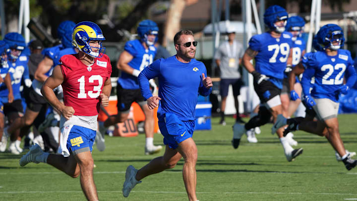 Jul 23, 2025; Los Angeles, CA, USA; Los Angeles Rams coach Sean McVay runs with quarterback Stetson Bennett (13) during training camp at Loyola Marymount University. Mandatory Credit: Kirby Lee-Imagn Images