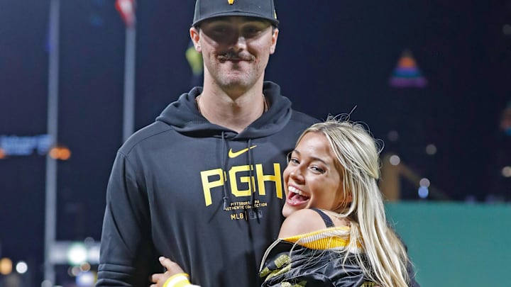 Pittsburgh Pirates starting pitcher Paul Skenes (30) poses with his girlfriend Louisiana State University gymnast Olivia Dunne (right) after Skenes made his major league debut against the Chicago Cubs at PNC Park. 