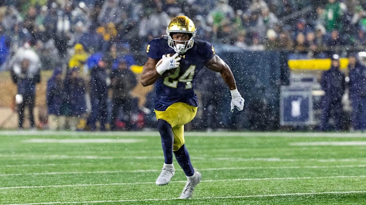 Nov 8, 2025; South Bend, Indiana, USA; Notre Dame Fighting Irish running back Jadarian Price (24) runs the ball against the Navy Midshipmen during the second half at Notre Dame Stadium. Mandatory Credit: Michael Caterina-Imagn Images