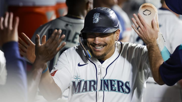 Sep 8, 2025; Seattle, Washington, USA; Seattle Mariners first baseman Josh Naylor (12) receives high-fives in the dugout after scoring a run against the St. Louis Cardinals during the sixth inning at T-Mobile Park. Mandatory Credit: Joe Nicholson-Imagn Images