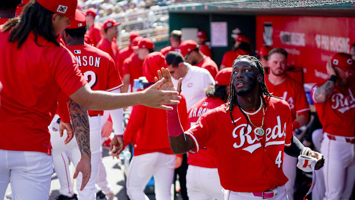 Cincinnati Reds shortstop Elly De La Cruz is embraced by his teammates after coming off the field in the first inning of a Cactus League game between the Cincinnati Reds and Los Angeles Dodgers, Monday, Feb. 24, 2025, at Goodyear Ballpark in Goodyear, Ariz.