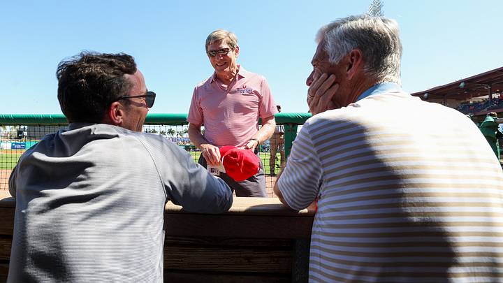 Feb 25, 2024; Clearwater, Florida, USA;  Philadelphia Phillies managing partner and principal owner John Middleton (center), president of baseball operations Dave Dombrowski and general manager Sam Fuld talk in the dugout before a game against the New York Yankees at BayCare Ballpark. Mandatory Credit: Nathan Ray Seebeck-USA TODAY Sports