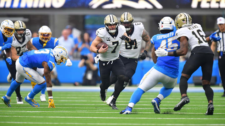 Oct 27, 2024; Inglewood, California, USA; New Orleans Saints tight end Taysom Hill (7) runs the ball against the Los Angeles Chargers during the first half at SoFi Stadium. Mandatory Credit: Gary A. Vasquez-Imagn Images