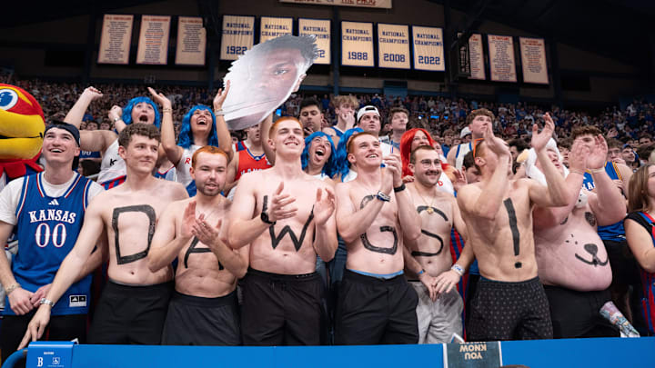 Kansas Jayhawks fans paint words on themselves during the game against Arizona Wildcats inside Allen Fieldhouse on Feb. 9, 2026.