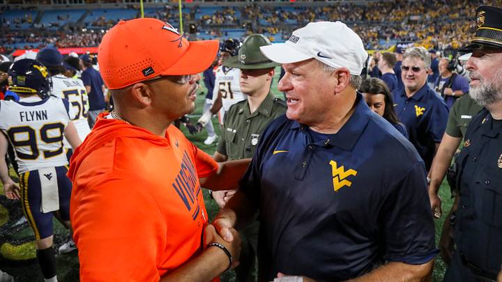 Sep 19, 2026; Charlotte, North Carolina, USA; West Virginia Mountaineers head coach Rich Rodriguez talks with Virginia Cavaliers head coach Tony Elliott after the game at Bank of America Stadium. Mandatory Credit: Ben Queen-Imagn Images Sep 19, 2026; Charlotte, North Carolina, USA; West Virginia Mountaineers head coach Rich Rodriguez talks with Virginia Cavaliers head coach Tony Elliott after the game at Bank of America Stadium. Mandatory Credit: Ben Queen-Imagn Images