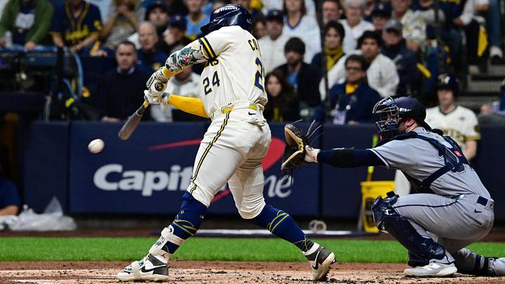 Oct 24, 2026; Milwaukee, Wisconsin, USA; Milwaukee Brewers catcher William Contreras (24) hits an RBI single against Tampa Bay Rays starting pitcher Drew Rasmussen (not pictured) and catcher Liam Hicks (34) during the first inning in game two of the 2026 World Series at American Family Field. Mandatory Credit: Benny Sieu-Imagn Images Oct 24, 2026; Milwaukee, Wisconsin, USA; Milwaukee Brewers catcher William Contreras (24) hits an RBI single against Tampa Bay Rays starting pitcher Drew Rasmussen (not pictured) and catcher Liam Hicks (34) during the first inning in game two of the 2026 World Series at American Family Field. Mandatory Credit: Benny Sieu-Imagn Images